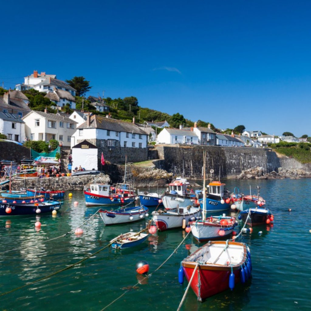 The small harbour town of Coverack in Cornwall showing boats and the town in the background.