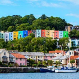 colourful houses on a hill in Bristol with the sae in front